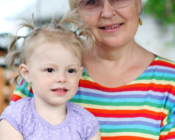 Grandmother outdoors on patio with baby