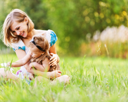 beautiful young mother daughter relaxing sitting grass