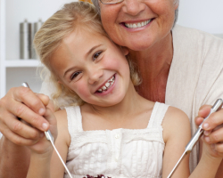 Happy grandmother eating a salad with granddaughter